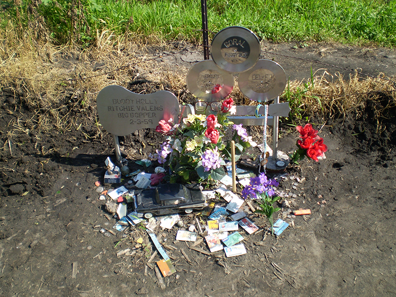 Three Stars Memorial Plaque with flowers A shot of the entire memorial with flowers and mementos left by fans and mourners.