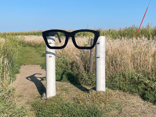 Three Stars Memorial Site Marker Large Glasses statue mark the site for visitors